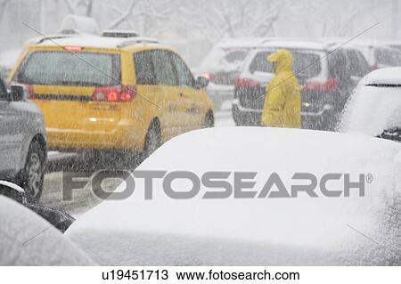 Stock Image - USA, New York City, city traffic in snowstorm. Fotosearch