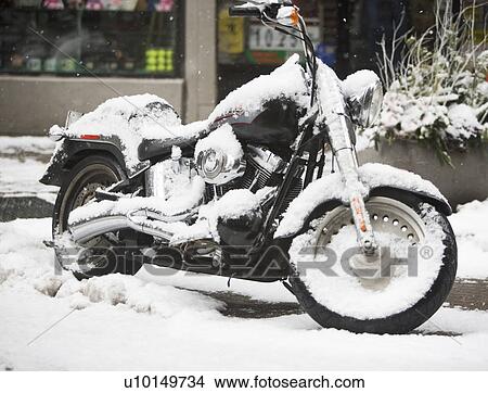 Picture - USA, New York City, motorbike covered with snow. Fotosearch
