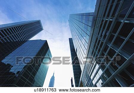 Stock Image - USA, New York City, New York, low angle view of modern office buildings. Fotosearch