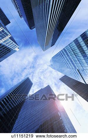 Stock Photo - USA, New York City, New York, upward view of modern office buildings. Fotosearch