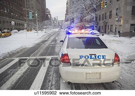 Stock Image - USA, New York City, police car on Park Avenue. Fotosearch