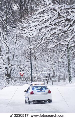Stock Photo - USA, New York City, police car on snowy road. Fotosearch