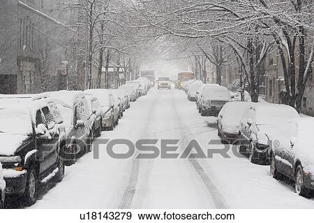 Stock Photo - USA, New York City, snowy street with rows of parked cars. Fotosearch