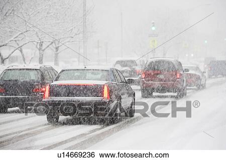 Stock Photograph - USA, New York City, traffic in blizzard. Fotosearch