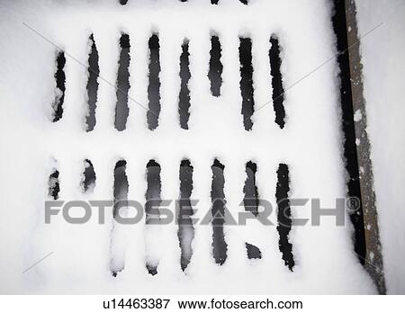 Stock Photo - USA, New York State, Brooklyn, Williamsburg, snow covered sewer grate. Fotosearch