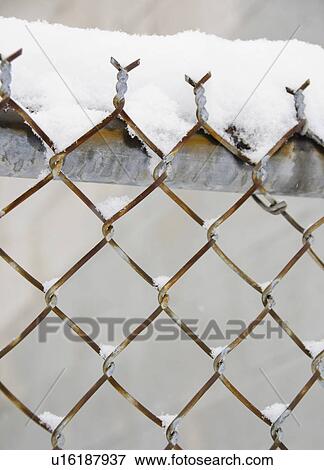 Stock Photo - USA, New York State, Brooklyn, Williamsburg, snow covered chainlink fence. Fotosearch