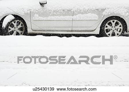 Stock Photo - USA, New York State, Brooklyn, Williamsburg, car on street during blizzard. Fotosearch