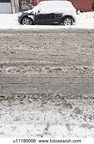 Stock Photograph - USA, New York State, Brooklyn, Williamsburg, tire tracks on snow covered street. Fotosearch