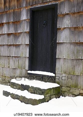 Stock Image - USA, New York State, Door to barn covered with snow. Fotosearch