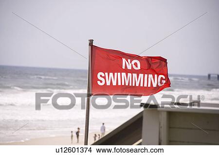Picture - USA, North Carolina, Outer Banks, Kill Devil Hills, no swimming sign on beach. Fotosearch
