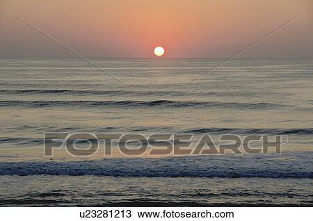 Stock Image - USA, North Carolina, Outer Banks, Kill Devil Hills, seascape at sunset. Fotosearch