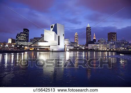 Stock Image - USA, Ohio, Rock and Roll Hall of Fame and Museum across frozen lake at dusk. Fotosearch