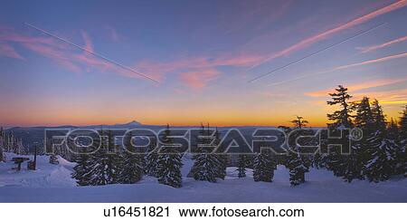 Stock Image - USA, Oregon, Snow covered field with Mount Jefferson in background, sunset. Fotosearch