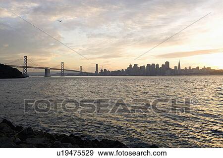 Stock Photo - USA, San Francisco, City skyline with Golden Gate Bridge. Fotosearch