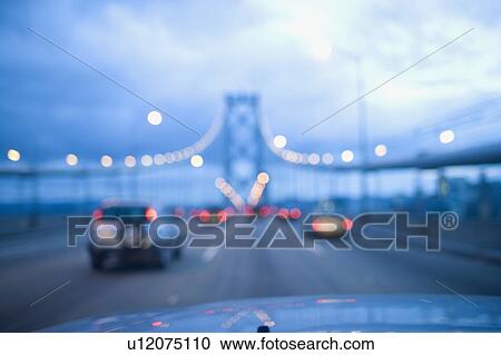 Stock Image - USA, San Francisco, Driving on Golden Gate Bridge. Fotosearch