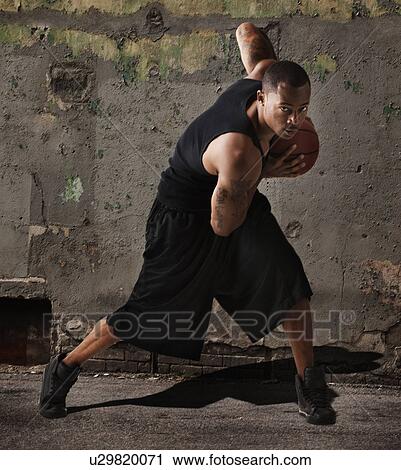 USA, Utah, Salt Lake City, man playing basketball in front of wall View Large Photo Image Stock Image - USA, Utah, Salt Lake City, man playing basketball in front of wall. Fotosearch