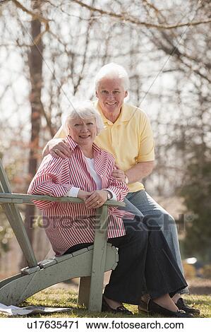 Stock Image - USA, Virginia, Richmond, portrait of senior couple in park. Fotosearch