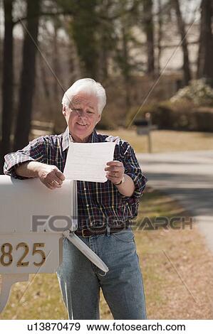 USA, Virginia, Richmond, senior man reading letters by mailbox View Large Photo Image Stock Photo - USA, Virginia, Richmond, senior man reading letters by mailbox. Fotosearch