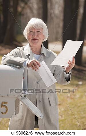 USA, Virginia, Richmond, senior woman reading letters by mailbox View Large Photo Image Stock Photograph - USA, Virginia, Richmond, senior woman reading letters by mailbox. Fotosearch