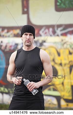 USA, Washington, Seattle, man in workout wear in front of graffiti wall View Large Photo Image Stock Photograph - USA, Washington, Seattle, man in workout wear in front of graffiti wall. Fotosearch