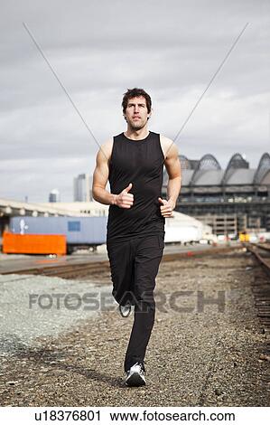 Stock Image - USA, Washington, Seattle, man jogging. Fotosearch