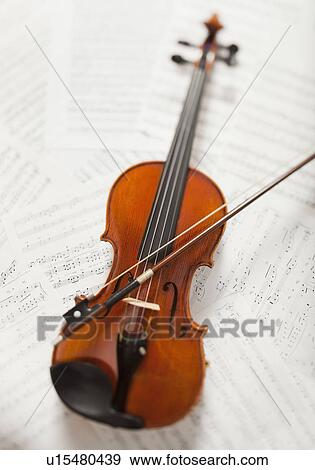 Violin on sheet music View Large Photo Image Stock Photo - Violin on sheet music. Fotosearch