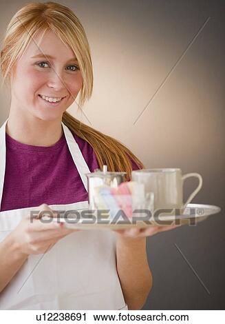 Waitress carrying tray with glass View Large Photo Image Stock Image - Waitress carrying tray with glass. Fotosearch
