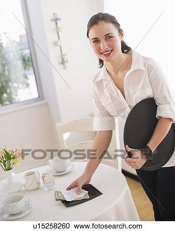 Stock Image - Waitress collecting bills. Fotosearch