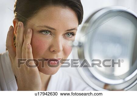 Woman applying cosmetics on face View Large Photo Image Stock Image - Woman applying cosmetics on face. Fotosearch