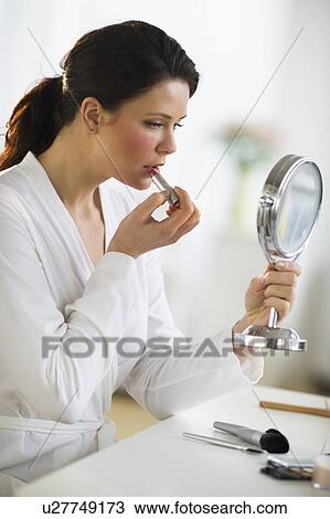 Woman applying lipstick View Large Photo Image Stock Image - Woman applying lipstick. Fotosearch