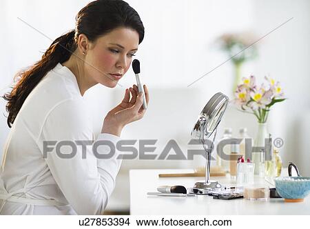 Picture - Woman doing make-up. Fotosearch