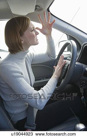 Stock Image - Woman driving car honking and gesturing. Fotosearch