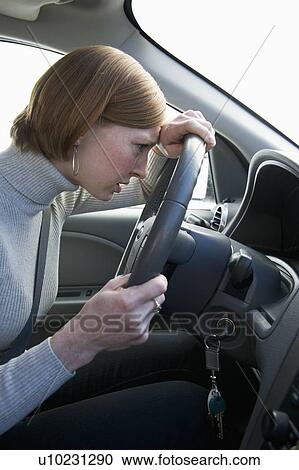 Woman driving car looking upset View Large Photo Image Stock Image - Woman driving car looking upset. Fotosearch