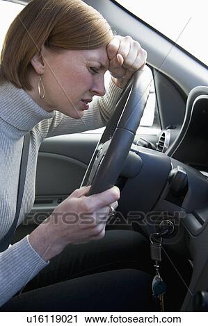 Woman driving car looking upset View Large Photo Image Stock Image - Woman driving car looking upset. Fotosearch