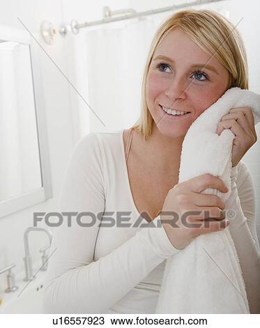 Stock Image - Woman drying face with towel. Fotosearch