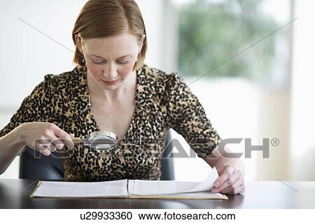 Woman examining documents View Large Photo Image Stock Image - Woman examining documents. Fotosearch
