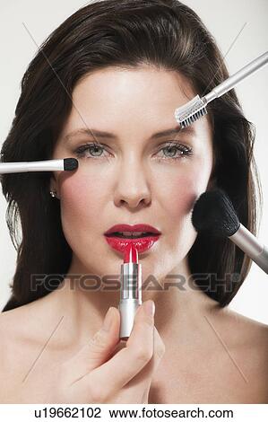 Stock Image - Woman having make up applied. Fotosearch