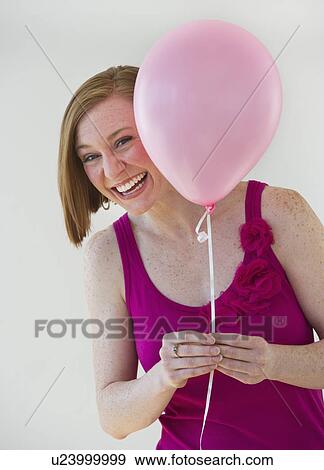 Stock Photo - Woman holding balloon. Fotosearch