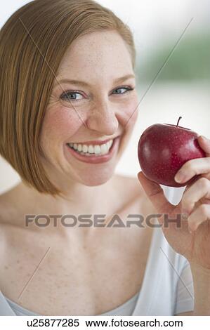 Stock Photography - Woman holding fresh apple. Fotosearch