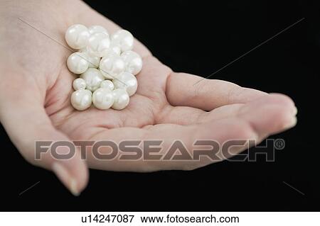 Stock Photo - Woman holding pearls. Fotosearch