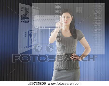 Woman in futuristic office touching computer panel View Large Photo Image Stock Photo - Woman in futuristic office touching computer panel. Fotosearch