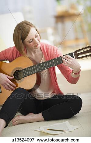 Stock Photo - Woman playing guitar. Fotosearch