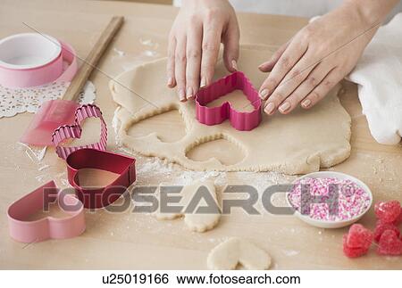 Woman preparing biscuits with pastry cutter View Large Photo Image Stock Photograph - Woman preparing biscuits with pastry cutter. Fotosearch