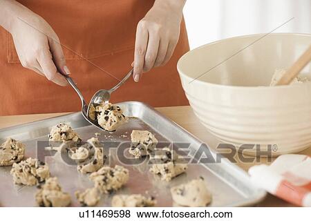 Stock Photo - Woman preparing cookies. Fotosearch