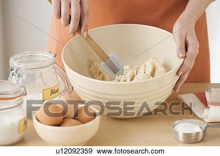 Woman preparing dough in bowl View Large Photo Image Stock Photo - Woman preparing dough in bowl. Fotosearch