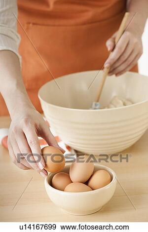 Stock Photo - Woman preparing dough in bowl. Fotosearch