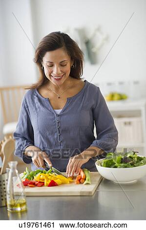 Woman preparing food in kitchen View Large Photo Image Stock Image - Woman preparing food in kitchen. Fotosearch