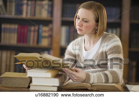 Woman reading book in library View Large Photo Image Stock Image - Woman reading book in library. Fotosearch