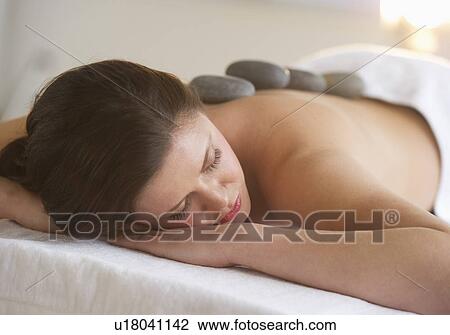 Woman receiving hot stone therapy View Large Photo Image Stock Image - Woman receiving hot stone therapy. Fotosearch