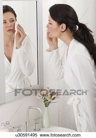 Woman removing make-up in bathroom View Large Photo Image Stock Photography - Woman removing make-up in bathroom. Fotosearch